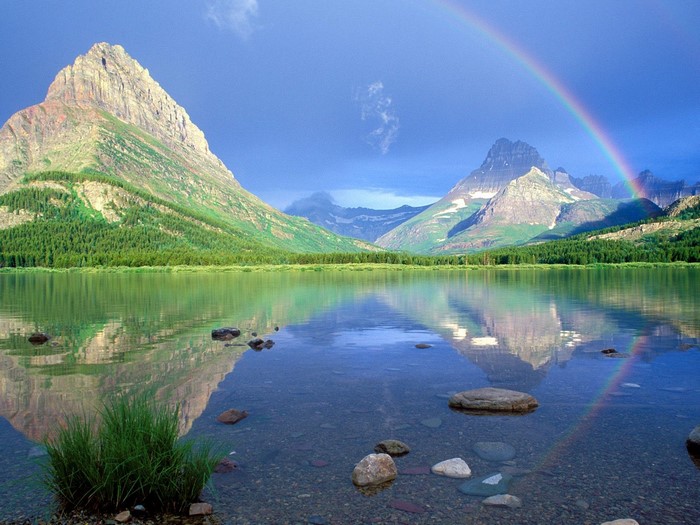 Lake reflection of mountains and rainbow