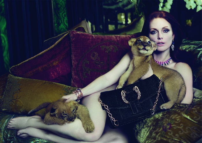 Julianne Moore with lion cubs on a sofa