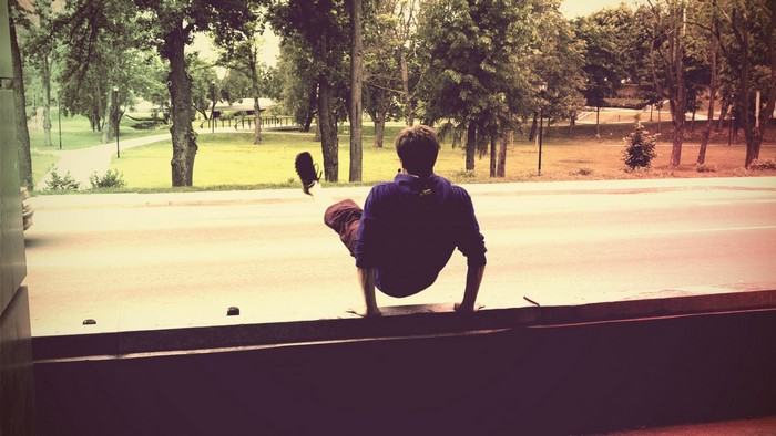 Man performing parkour on a ledge