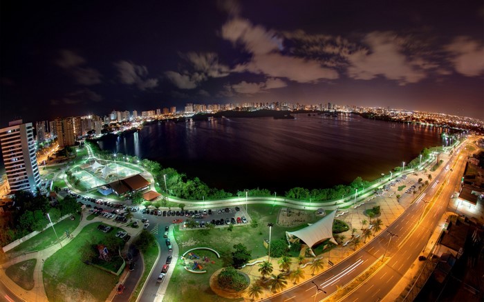 Night cityscape with a lake and urban skyline