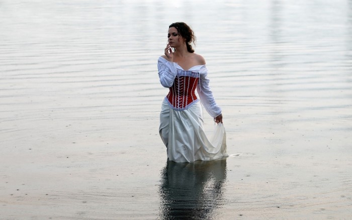 Woman in Elegant Dress Standing in Water