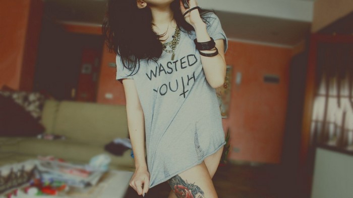 Woman in a grey t-shirt with tattoo