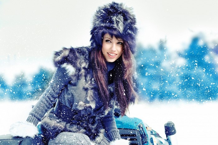 Woman in fur hat and coat in snow