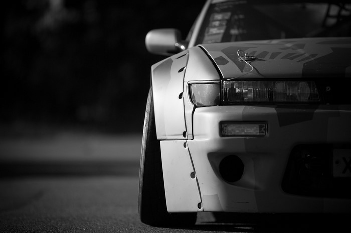 Monochrome Nissan S13 sports car with widebody kit
