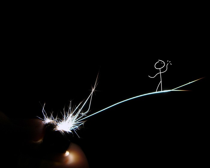 Stick figure on a light line with sparkler