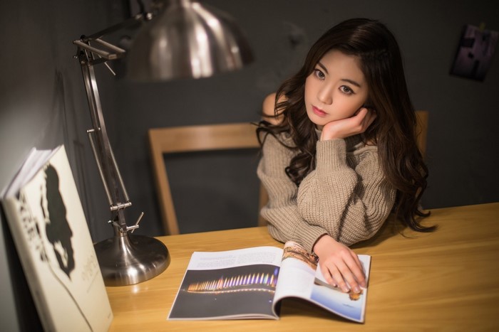 Woman reading a magazine at a desk