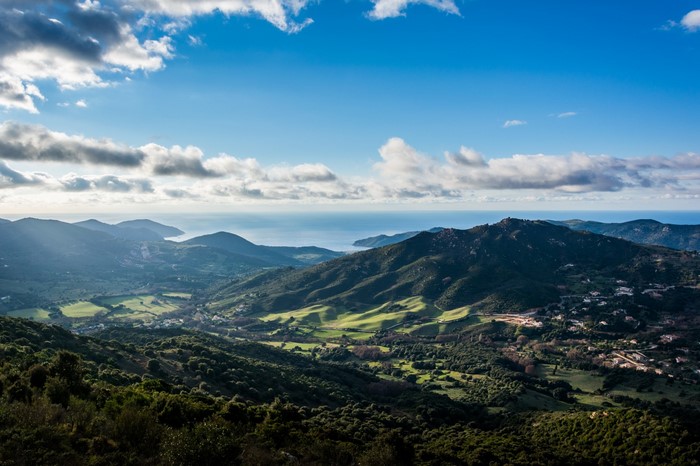 Sunlit valley and hills overlooking the sea