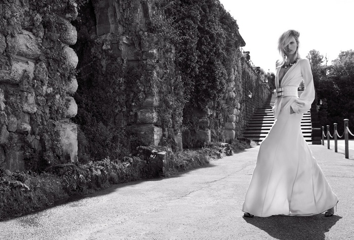 Karolina Kurkova in a white dress on a stairway