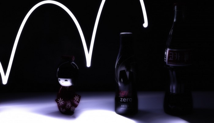 Kokeshi doll and Coca-Cola bottles with light painting