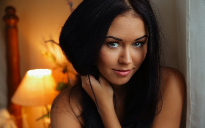 Woman with long black hair and blue eyes