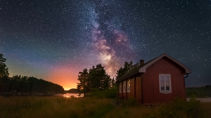 Red cabin under the Milky Way galaxy