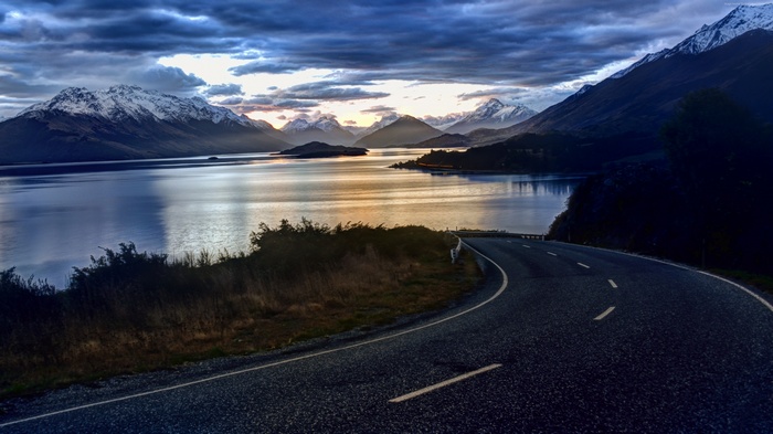 Road by Lake and Snow-Capped Mountains