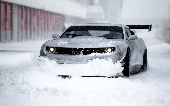 Chevrolet Camaro driving through snow