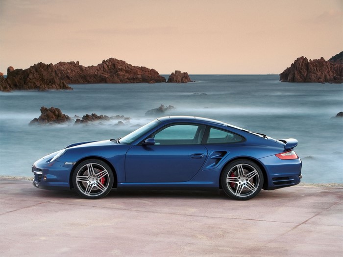 Blue Porsche 911 sports car by the sea
