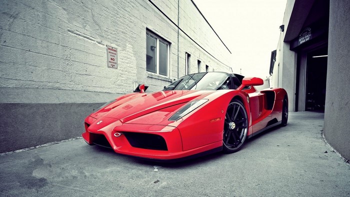 Red Ferrari Enzo Sports Car in Urban Setting