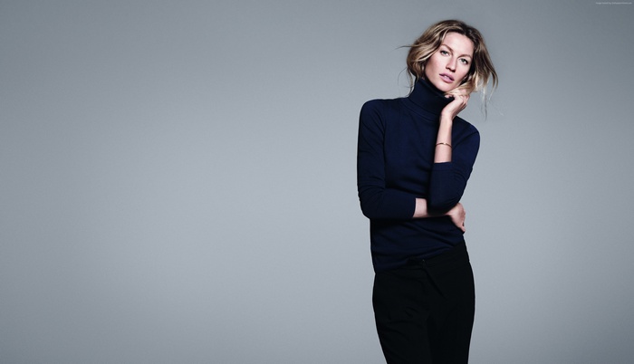 Gisele Bundchen in a dark turtleneck and black pants