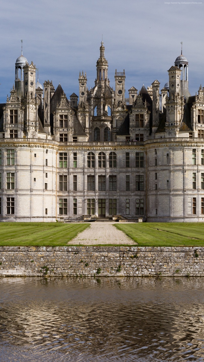 Chateau de Chambord castle on a sunny day with water