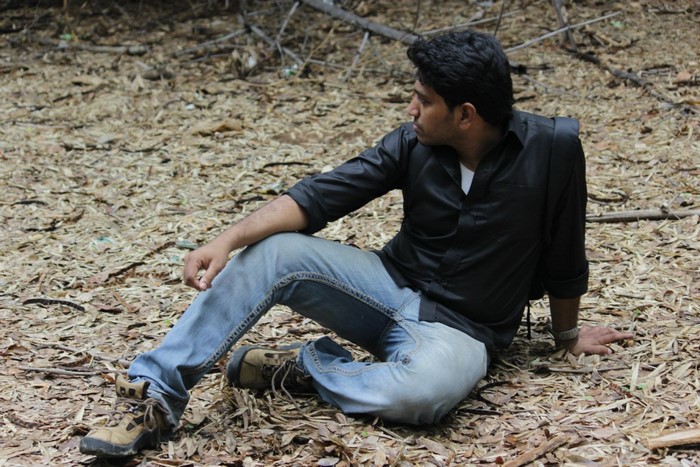 Man sitting on the ground in a forest
