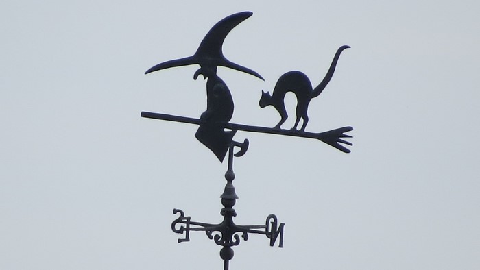 Witch and cat on a broomstick weathervane