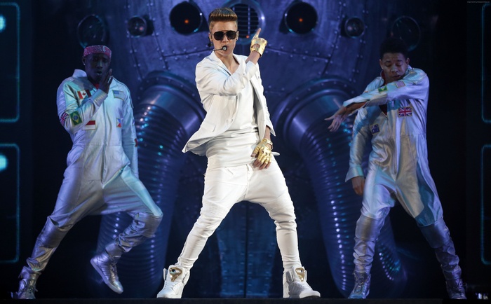 Justin Bieber performing on stage with dancers
