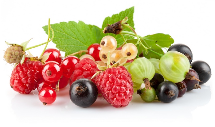 Assortment of fresh berries including raspberries, currants, and gooseberries