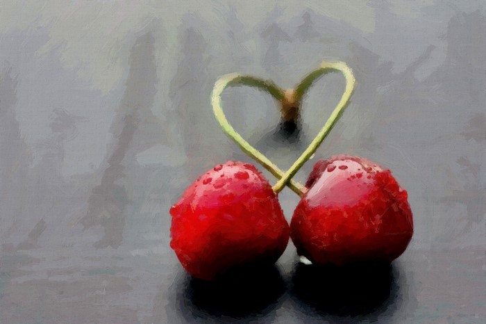 Two cherries with stems forming a heart shape