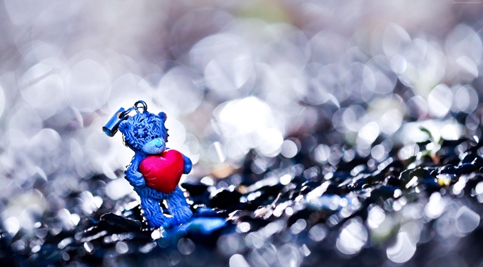 Blue teddy bear with red heart and lock