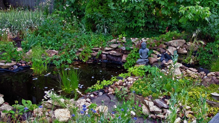 Zen garden with pond and Buddha statue