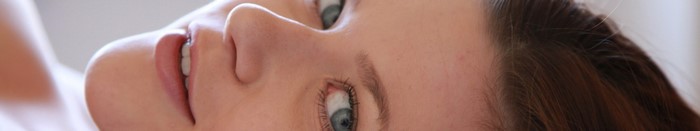 Close-up of a woman's face with blue eyes and brown hair