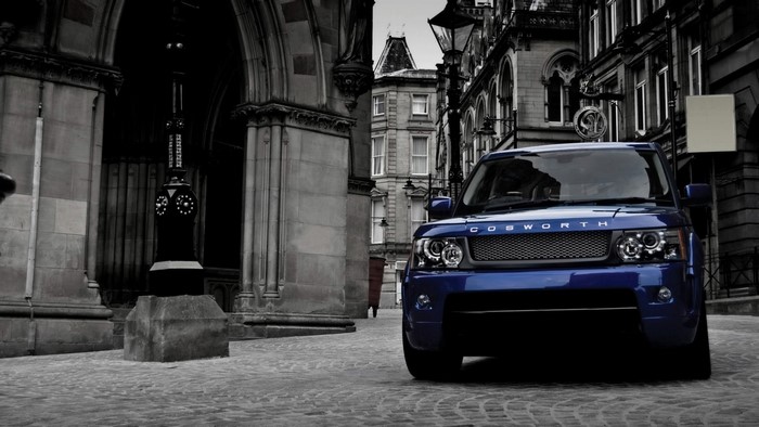 Blue Range Rover Cosworth on Cobblestone Street