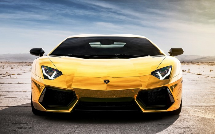 Gold Lamborghini Aventador parked on asphalt road