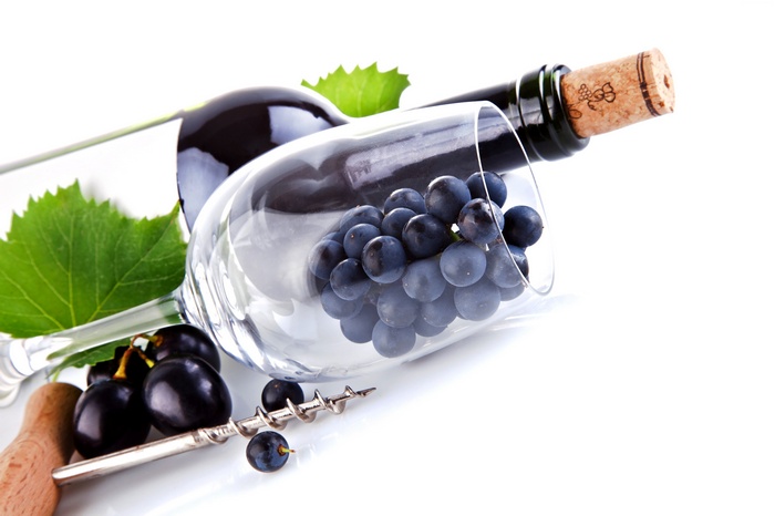Wine bottle, grapes, wine glass, and corkscrew