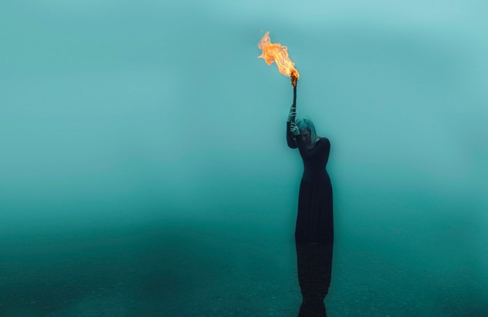Woman holding a torch underwater