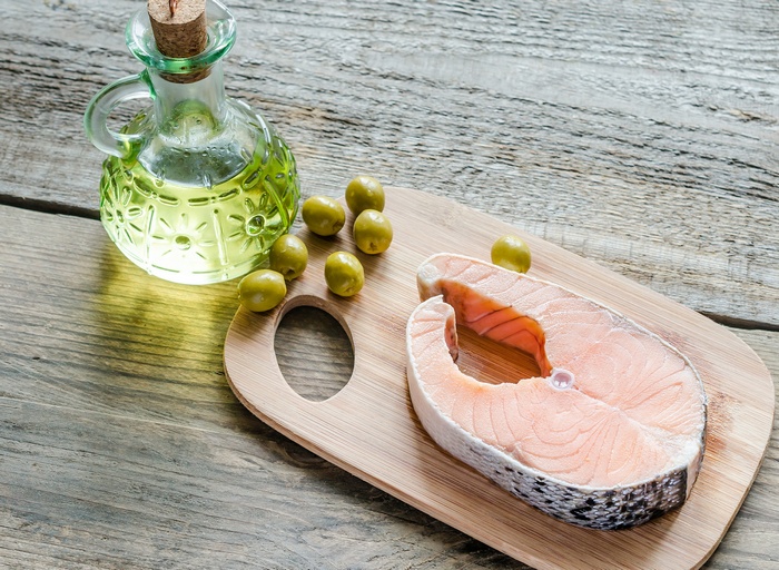 Salmon steak with olives and olive oil