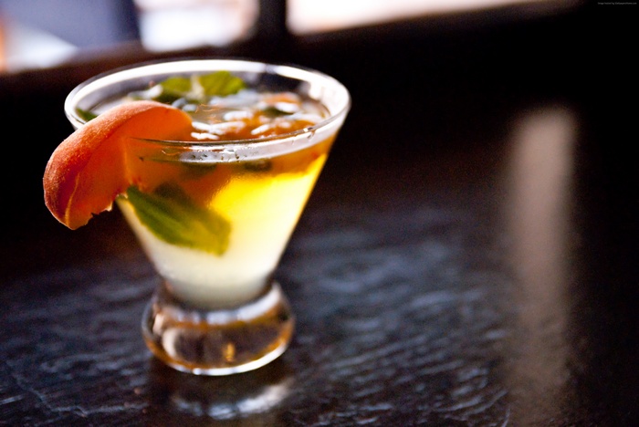 Cocktail with peach slice and mint