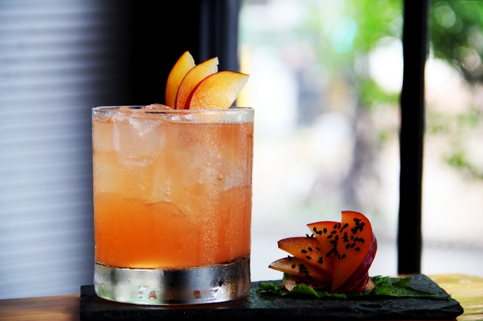 Cocktail with peach slices and mint
