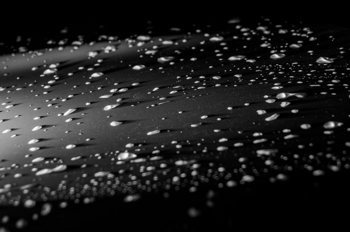 Macro photography of water drops on a dark surface