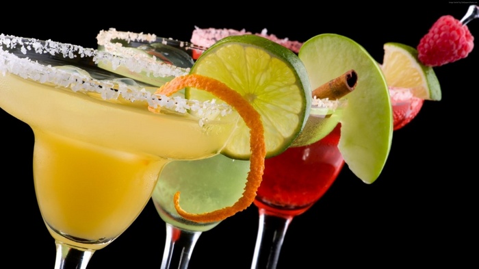 Cocktails with fruit garnishes and sugar rim