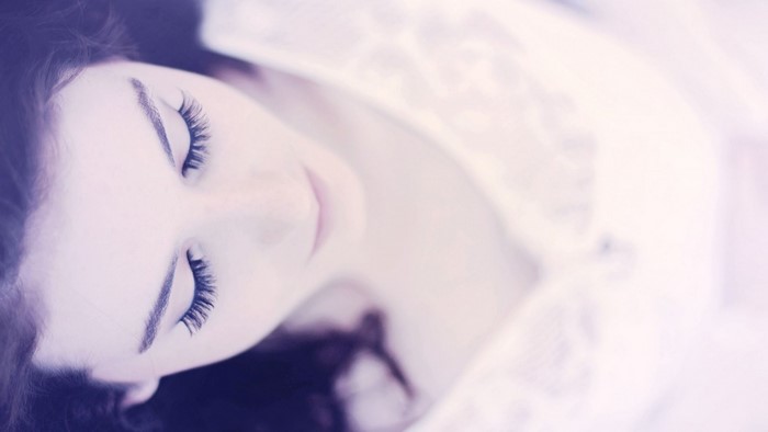 Close-up of a woman's face with eyes closed