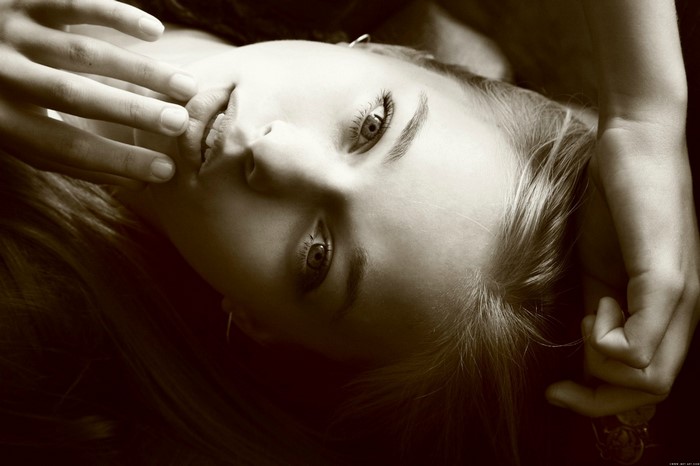 Portrait of a young woman with hand near face