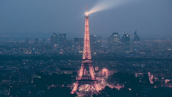 Eiffel Tower illuminated at night with Paris cityscape