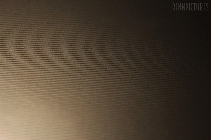 Textured surface with horizontal lines and light