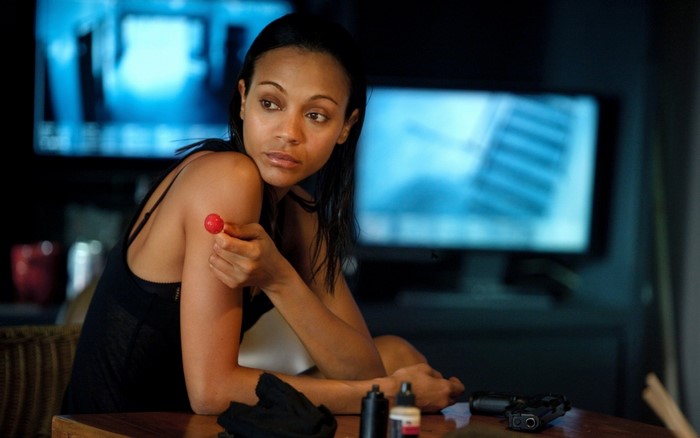 Zoe Saldana holding a red lollipop