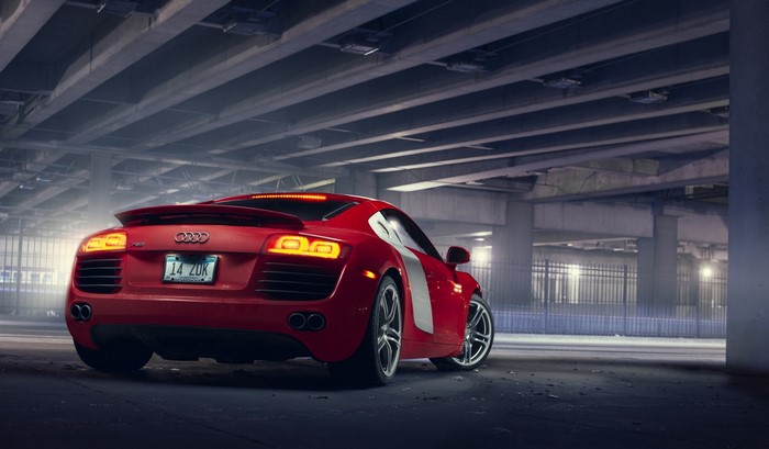 Red Audi R8 parked under a bridge