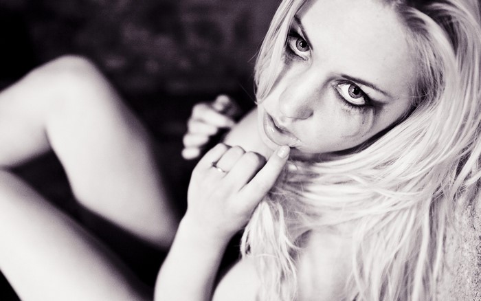 Black and white portrait of a blonde woman with makeup