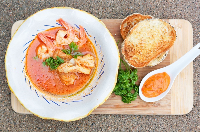Seafood soup with shrimp, toast, and sauce