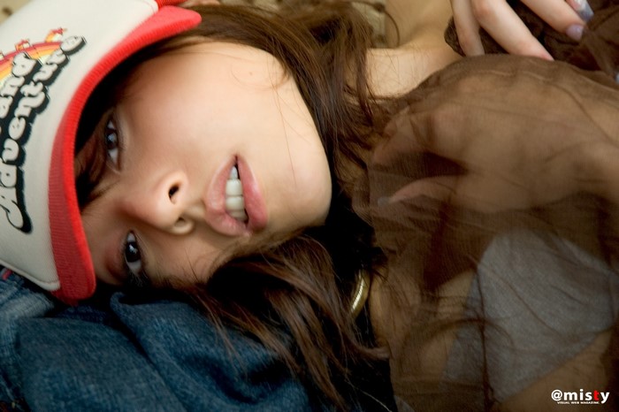 Reina Nakamata wearing a trucker hat and brown top