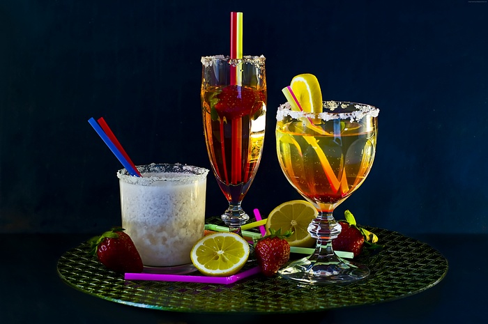 Cocktails with strawberries, lemon, and sugar rim