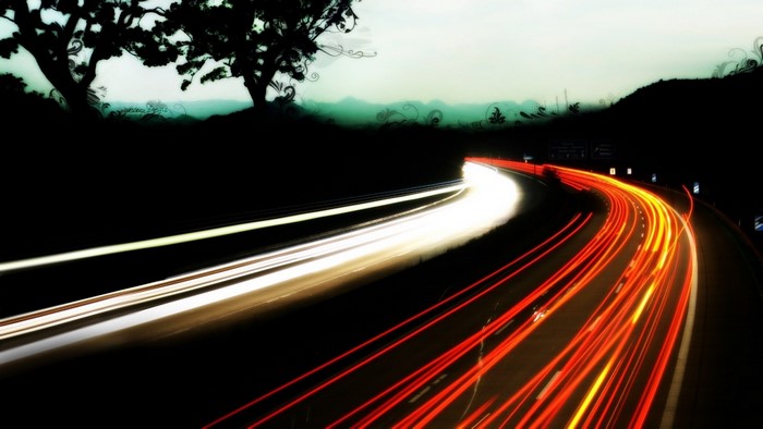 Long exposure of a highway at night with light trails