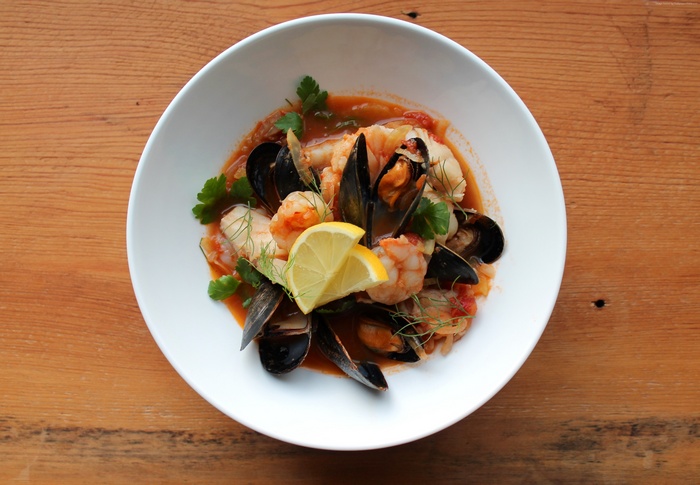 Seafood soup with mussels, shrimp, and lemon